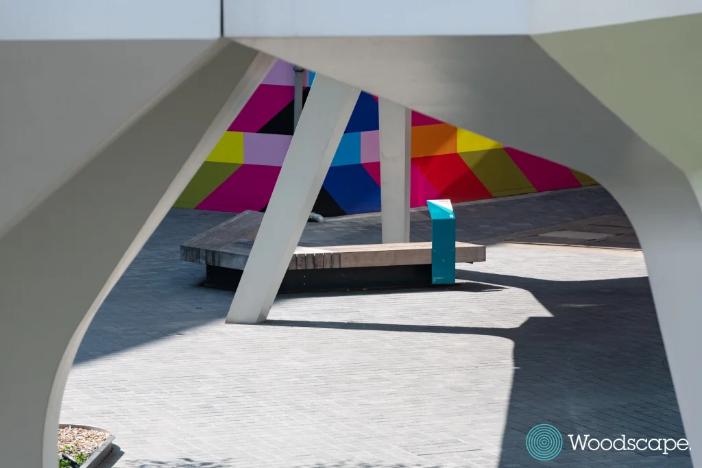 sustainable beautiful hardwood bench under the tide bridge in the Design District of the Greenwich Peninsula